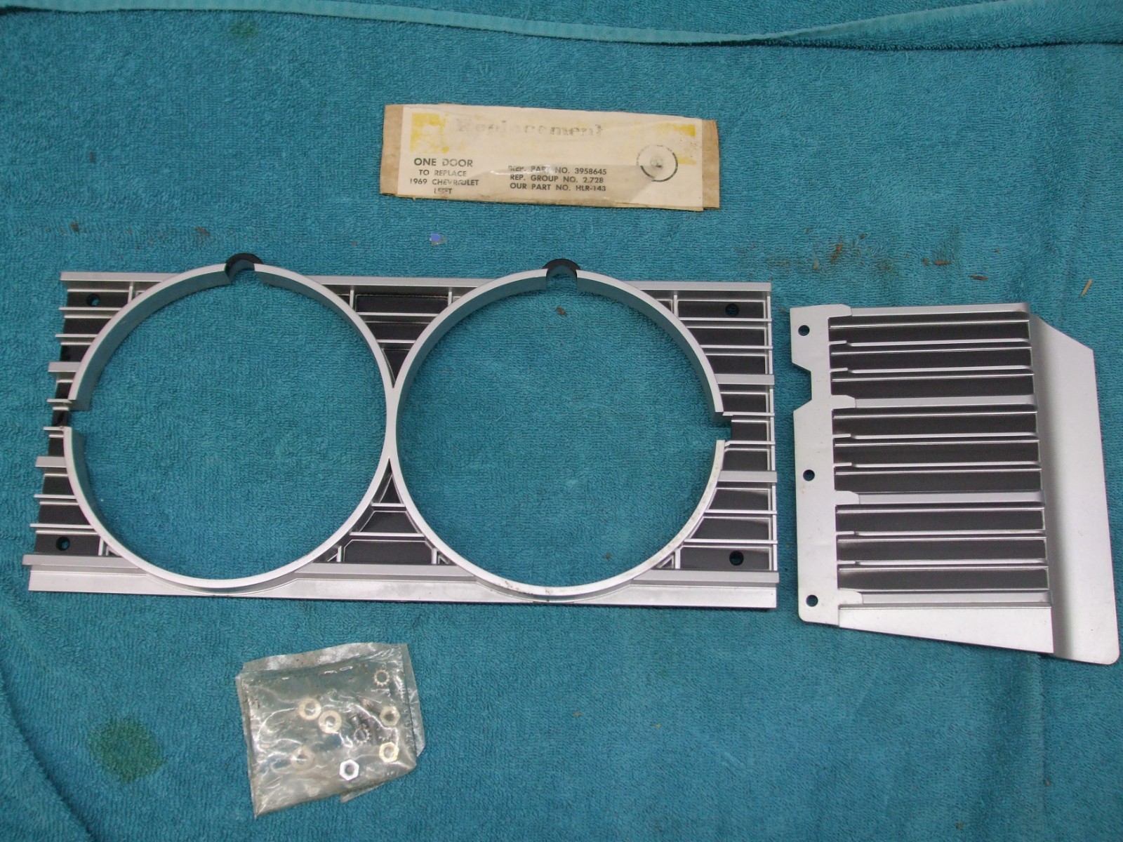 1969 Chevy Impala Left headlight plastic grill and trim nos 3958645 no hardware